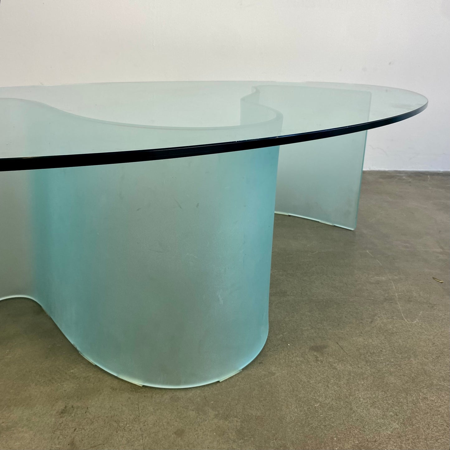 Glass coffee table with wave legs