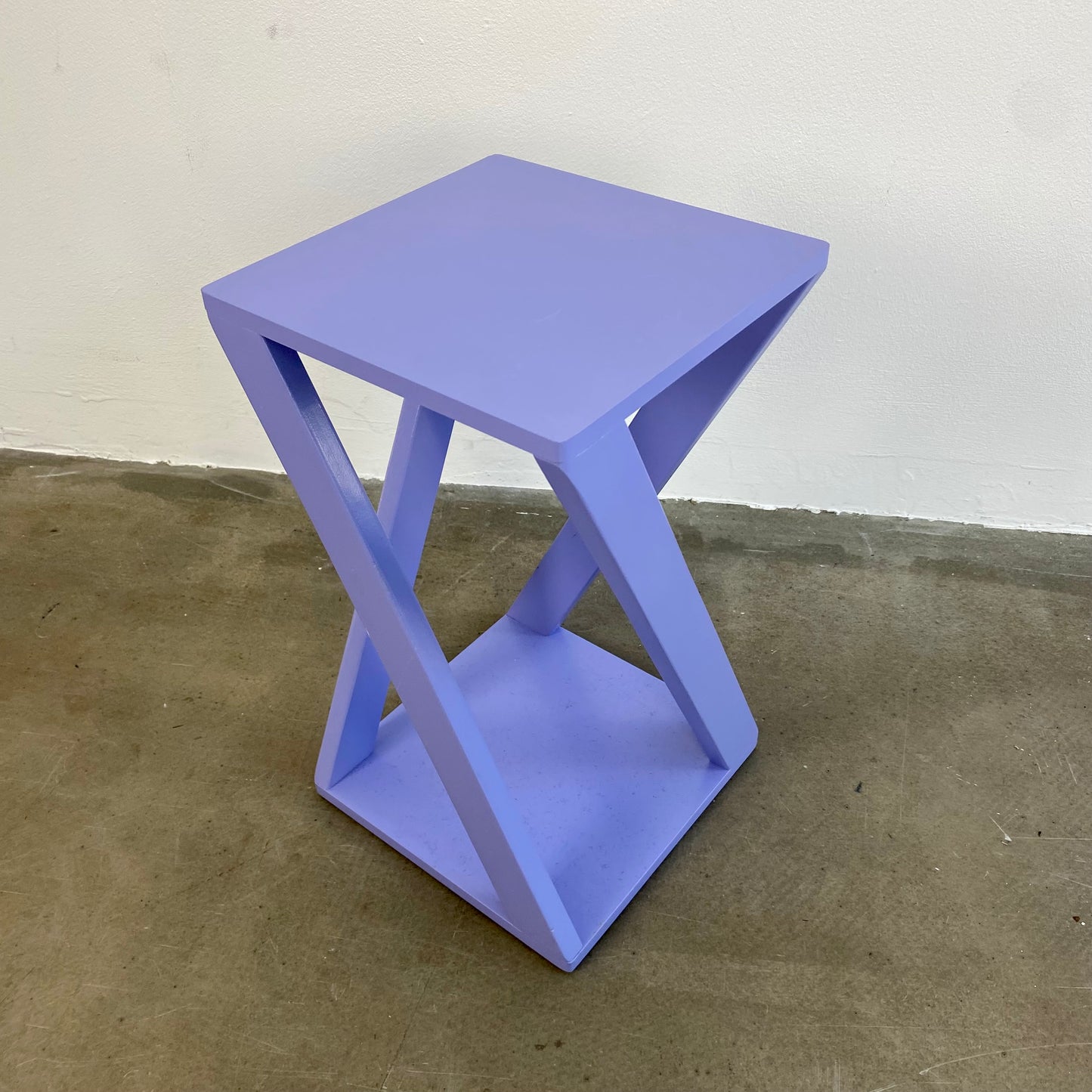 Lavender colored display side table of wood
